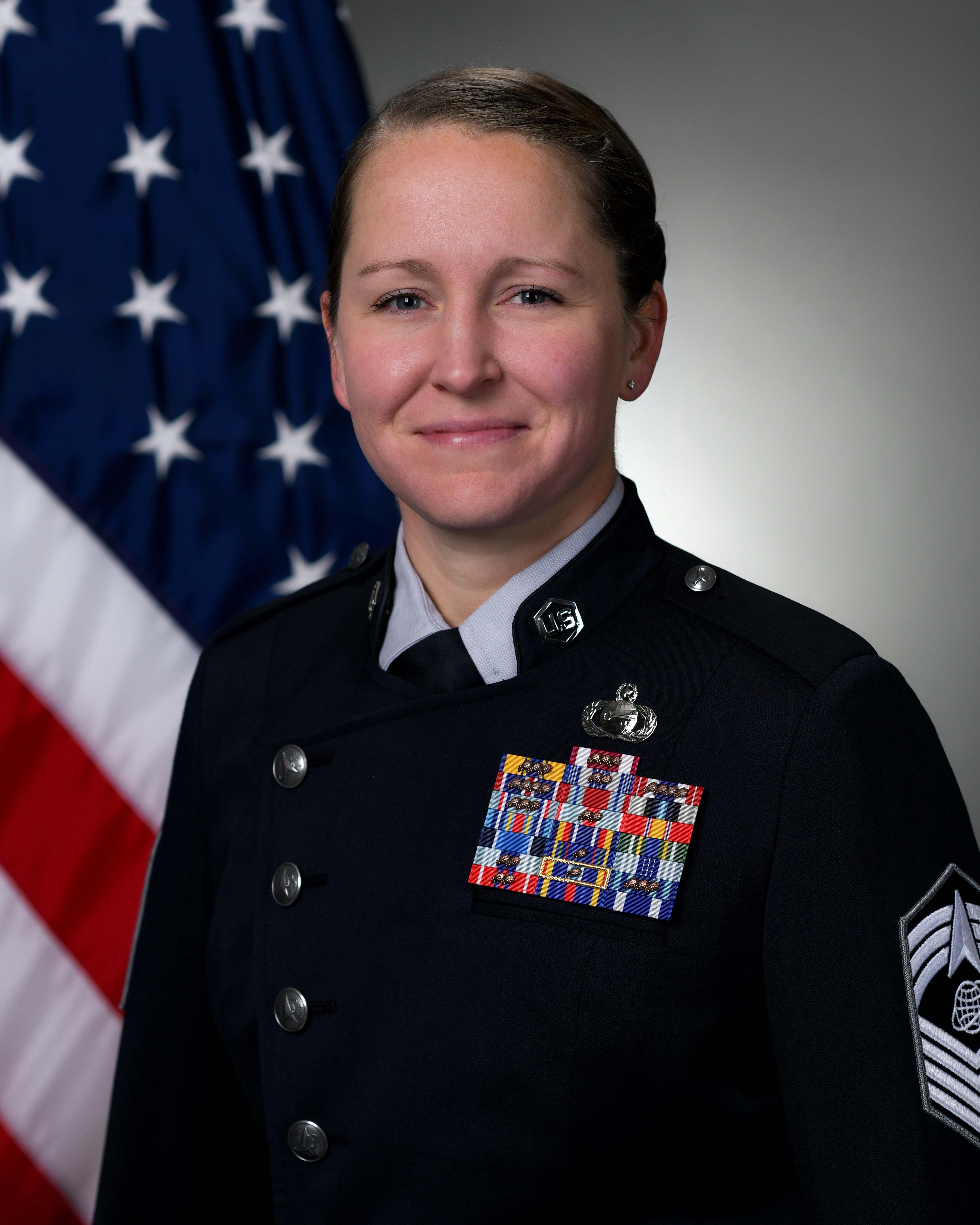 Official photo of Delta 11 Senior Enlisted Leader CMSgt Steven A. Sweeden with U.S. flag behind him