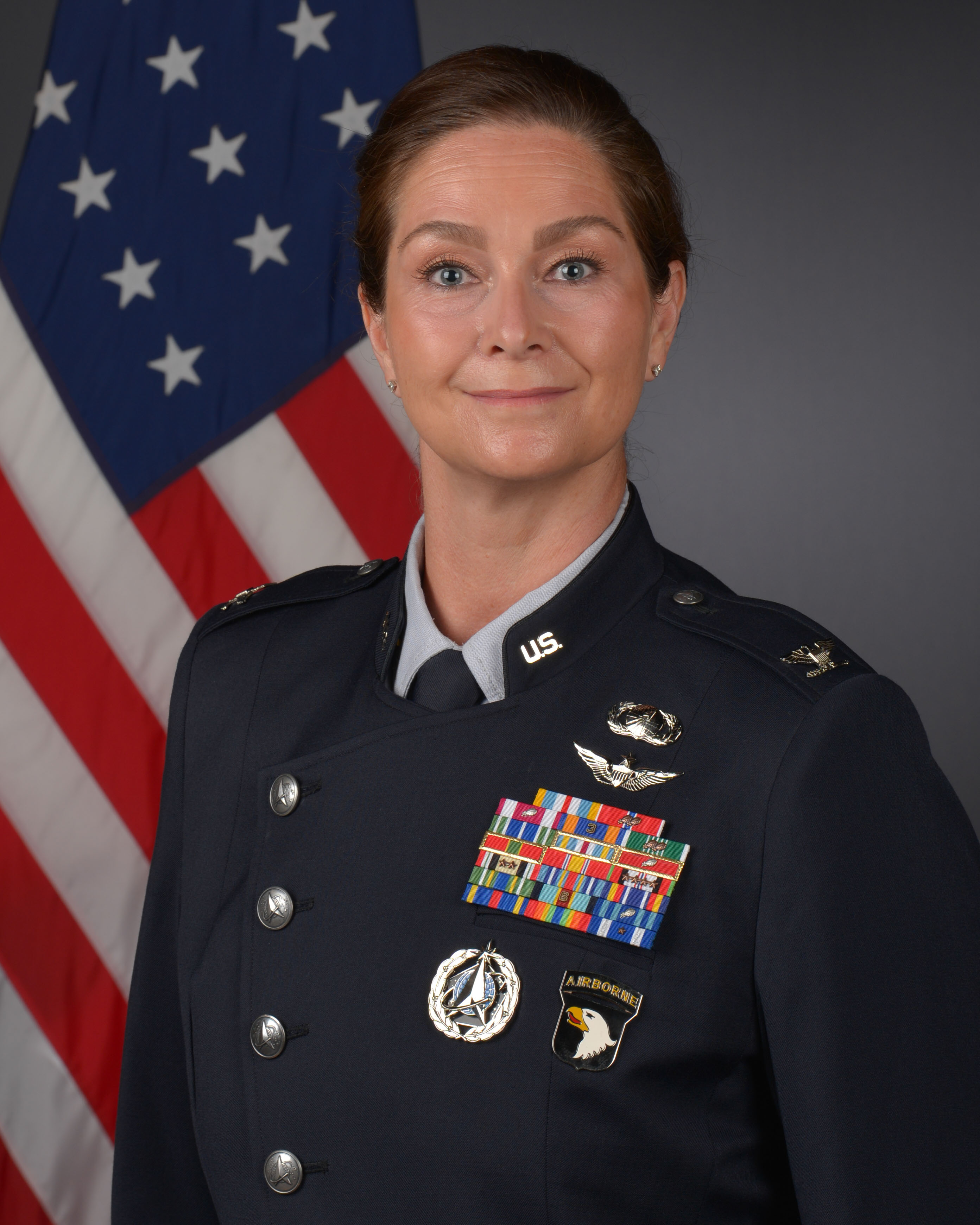 Official Photo of Delta 10 Commander Col Shannon DaSilva with U.S. flag behind her